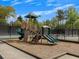 Community playground with slides and climbing equipment on a cushioned surface at 11770 Ashwick Pl, Johns Creek, GA 30005