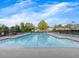 Sparkling community pool with clear blue water on a sunny day is ready for residents to enjoy at 11770 Ashwick Pl, Johns Creek, GA 30005