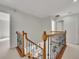 A beautiful staircase with wooden handrails, iron balusters and natural light at 11770 Ashwick Pl, Johns Creek, GA 30005