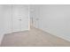 Carpeted bedroom with double doors and an open bathroom doorway at 1512 Parks Edge Nw Ln, Atlanta, GA 30318