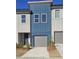 Charming townhome exterior with a one-car garage and a modern blue facade at 1512 Parks Edge Nw Ln, Atlanta, GA 30318