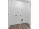 Laundry room boasts wooden style vinyl flooring and shelving above hookups at 1512 Parks Edge Nw Ln, Atlanta, GA 30318