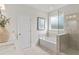 Relaxing bathroom with a soaking tub and a glass shower enclosure at 5260 Trescott Path, Cumming, GA 30028