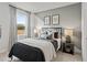 Stylish bedroom with neutral tones, a comfortable bed, and natural light at 5260 Trescott Path, Cumming, GA 30028