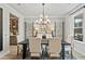 Elegant dining room with modern chandelier, a large table, and access to a butler's pantry at 5260 Trescott Path, Cumming, GA 30028