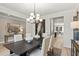 Stylish dining room featuring a modern chandelier, sleek table setting, and sophisticated decor at 5260 Trescott Path, Cumming, GA 30028
