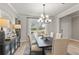 Well-lit dining area with stylish decor, modern chandelier, and a view of the outdoors at 5260 Trescott Path, Cumming, GA 30028