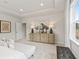 Bright and airy main bedroom with modern furniture, tray ceilings and natural light at 5260 Trescott Path, Cumming, GA 30028