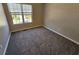 Cozy bedroom with a large window providing natural light and neutral carpeting at 5922 Graywood Cir, Mableton, GA 30126