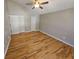 Bright bedroom with hardwood floors, a ceiling fan, and white doors at 5922 Graywood Cir, Mableton, GA 30126