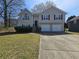 Traditional two-story home with a well-maintained lawn and a two-car garage at 5922 Graywood Cir, Mableton, GA 30126