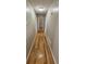 Hallway with beautiful wood flooring and neutral paint, connecting various rooms in the home at 5922 Graywood Cir, Mableton, GA 30126