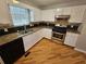 Well-lit kitchen featuring granite countertops, stainless steel appliances, and hardwood flooring at 5922 Graywood Cir, Mableton, GA 30126