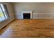 Spacious living room featuring a fireplace, hardwood floors, and large windows at 5922 Graywood Cir, Mableton, GA 30126