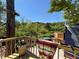 Backyard deck with a view of the green space and wooded forest behind the home at 2220 Wellington Cir, Lithonia, GA 30058