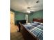 Spacious bedroom featuring a large bed, dark wood furniture, and a ceiling fan at 2220 Wellington Cir, Lithonia, GA 30058