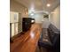 An open bedroom includes a bed area and a seating area with hardwood floors at 2220 Wellington Cir, Lithonia, GA 30058