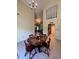 Open-concept dining area with vaulted ceiling, tile flooring, and views of the kitchen and living spaces at 2220 Wellington Cir, Lithonia, GA 30058
