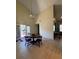 Spacious dining room with vaulted ceiling, wooden table, tiled floor, and sliding door at 2220 Wellington Cir, Lithonia, GA 30058