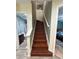 Hallway featuring the stairway to the second floor and access to an adjacent bathroom and bedroom at 2220 Wellington Cir, Lithonia, GA 30058