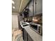 Cozy kitchen with gray cabinetry, tiled backsplash, stainless steel appliances, and tile flooring at 2220 Wellington Cir, Lithonia, GA 30058