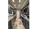 Galley kitchen with modern appliances, stylish backsplash, and ample cabinet space at 2220 Wellington Cir, Lithonia, GA 30058