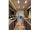Galley style kitchen featuring stainless appliances, tiled backsplash, and gray cabinets with a view to dining area at 2220 Wellington Cir, Lithonia, GA 30058