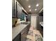 Gray kitchen with stainless steel appliances, double sink, tiled floor, and a view from the window at 2220 Wellington Cir, Lithonia, GA 30058