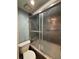 Bathroom featuring a glass-enclosed shower and tub with tiled walls at 2220 Wellington Cir, Lithonia, GA 30058