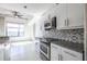 Modern kitchen boasting stainless steel oven, granite countertops, mosaic backsplash and updated appliances at 335 W Ponce De Leon Ave # 506, Decatur, GA 30030