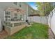 View of fenced backyard with patio, grass, trees, and privacy fence at 485 Crescent Woode Dr, Dallas, GA 30157