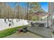 Backyard deck and patio area with an outdoor dining set and white privacy fence at 485 Crescent Woode Dr, Dallas, GA 30157