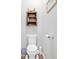 Cozy half bathroom with a toilet, toilet paper holder, wooden cabinet, and small trashcan at 485 Crescent Woode Dr, Dallas, GA 30157
