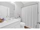 Clean bathroom with white cabinetry, tub/shower, and decorative accents at 485 Crescent Woode Dr, Dallas, GA 30157