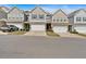 View of well maintained townhomes with two-car garage and a paved driveway at 485 Crescent Woode Dr, Dallas, GA 30157