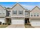 Charming townhome with a two-car garage, stone accents, and well-maintained landscaping at 485 Crescent Woode Dr, Dallas, GA 30157