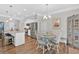 Kitchen island with bar stool seating and stainless appliances, adjacent dining area at 485 Crescent Woode Dr, Dallas, GA 30157