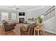 Cozy living room featuring a fireplace, large windows, and an adjacent staircase at 485 Crescent Woode Dr, Dallas, GA 30157
