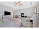 Bright main bedroom boasts a ceiling fan, a dresser, and a sitting area at 485 Crescent Woode Dr, Dallas, GA 30157