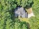 Aerial view of a home surrounded by lush greenery at 718 Fincher Rd, Covington, GA 30016