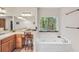 Well-lit bathroom boasting a soaking tub with a view, and a vanity with and sinks at 718 Fincher Rd, Covington, GA 30016