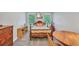 Sunny bedroom featuring natural light from two windows, and natural wood furniture at 718 Fincher Rd, Covington, GA 30016