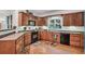 Traditional kitchen showcasing wood cabinets and countertops and black appliances at 718 Fincher Rd, Covington, GA 30016