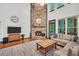 Open living room boasts a stone fireplace and natural light at 718 Fincher Rd, Covington, GA 30016