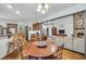 Open-concept living space with fireplace, kitchen bar, and dining area at 718 Fincher Rd, Covington, GA 30016
