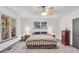 Cozy main bedroom with abundant light and ceiling fan at 718 Fincher Rd, Covington, GA 30016