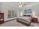 Spacious main bedroom with views to the wooded backyard and a ceiling fan at 718 Fincher Rd, Covington, GA 30016
