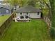 This backyard features a well-kept lawn, a patio with an outdoor seating area, and a surrounding fence at 1963 Main Nw St, Atlanta, GA 30318