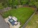An aerial view of a green backyard, an outdoor seating area, and a wooden fence at 1963 Main Nw St, Atlanta, GA 30318