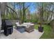 Inviting backyard features a cozy patio seating area, perfect for outdoor entertaining and relaxation surrounded by lush greenery at 1963 Main Nw St, Atlanta, GA 30318